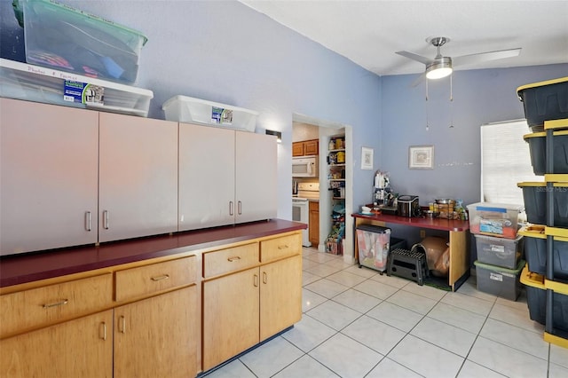1111 Liberty Ave, Mount Dora, FL 32757 - kitchen featuring white appliances, a ceiling fan, and light tile patterned flooring
