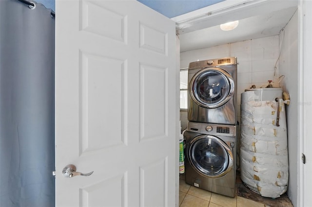 1111 Liberty Ave, Mount Dora, FL 32757 - laundry room with stacked washing machine and dryer and tile patterned flooring
