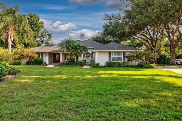 1947 Broadleaf Ct, Windermere, FL 34786 - ranch-style home with a front lawn, a chimney, stucco siding, and a shingled roof