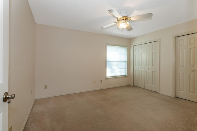 1947 Broadleaf Ct, Windermere, FL 34786 - unfurnished bedroom featuring light colored carpet, multiple closets, baseboards, and ceiling fan