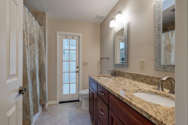 1947 Broadleaf Ct, Windermere, FL 34786 - full bath featuring double vanity, toilet, a textured ceiling, and tile patterned floors