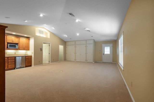 1947 Broadleaf Ct, Windermere, FL 34786 - unfurnished living room featuring vaulted ceiling, baseboards, light carpet, and recessed lighting