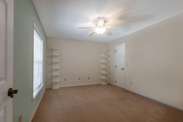 1947 Broadleaf Ct, Windermere, FL 34786 - spare room with light colored carpet, ceiling fan, baseboards, and a textured ceiling