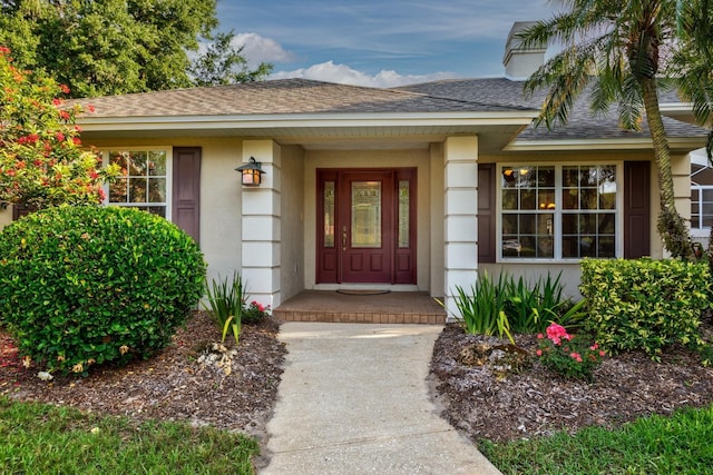 1947 Broadleaf Ct, Windermere, FL 34786 - view of exterior entry featuring roof with shingles and stucco siding