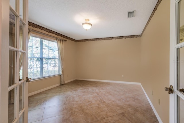 1947 Broadleaf Ct, Windermere, FL 34786 - unfurnished room with a textured ceiling, light tile patterned floors, baseboards, and french doors