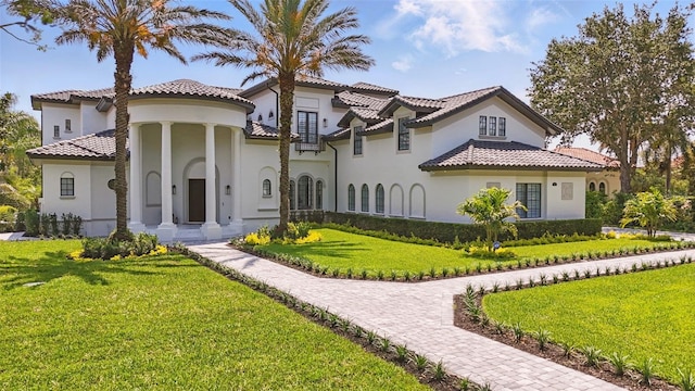 9259 Tibet Pointe Cir, Windermere, FL 34786 - mediterranean / spanish house featuring stucco siding, a front yard, and a tile roof