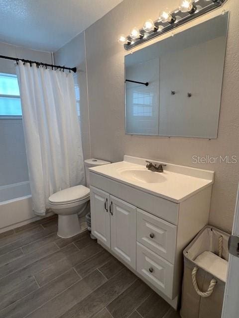1620 Hialeah St, Orlando, FL 32808 - bathroom featuring vanity, toilet, shower / bath combination with curtain, and wood tiled floors
