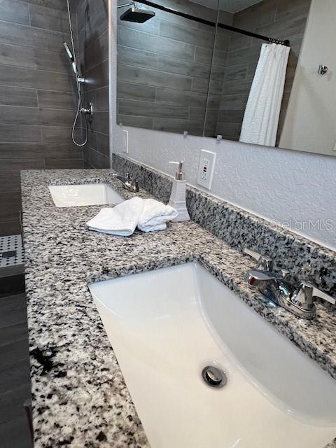 1620 Hialeah St, Orlando, FL 32808 - bathroom with tiled shower and double vanity