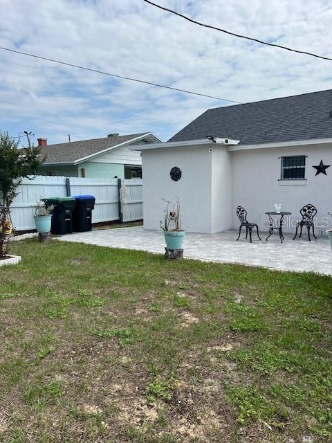 1620 Hialeah St, Orlando, FL 32808 - back of property with a patio and stucco siding