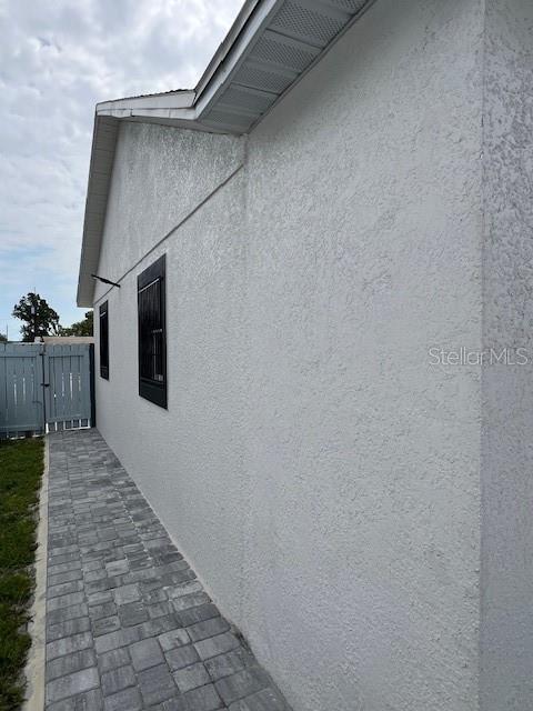 1620 Hialeah St, Orlando, FL 32808 - view of side of property with stucco siding