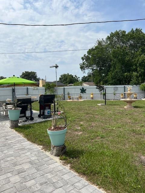 1620 Hialeah St, Orlando, FL 32808 - view of yard featuring a patio area