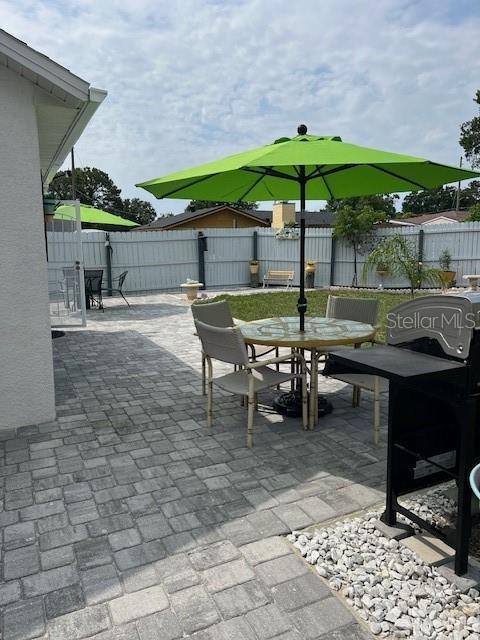 1620 Hialeah St, Orlando, FL 32808 - fenced backyard with outdoor dining area and a patio area