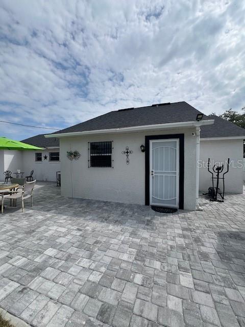 1620 Hialeah St, Orlando, FL 32808 - back of house featuring a patio and stucco siding
