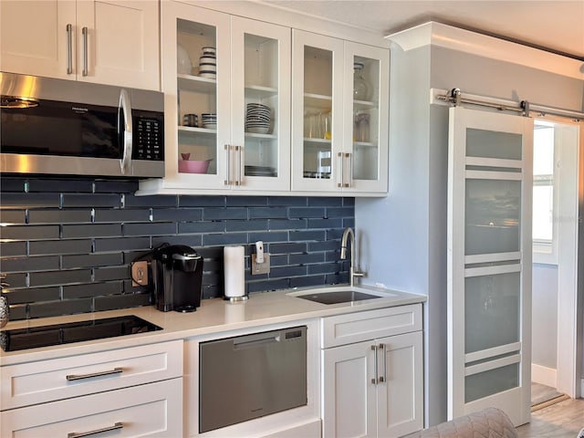 935 S Atlantic Ave Unit 244, Daytona Beach, FL 32118 - kitchen with appliances with stainless steel finishes, a sink, decorative backsplash, and white cabinets