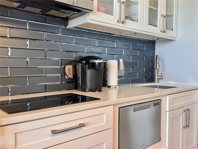 935 S Atlantic Ave Unit 244, Daytona Beach, FL 32118 - kitchen featuring a sink, backsplash, white cabinetry, light countertops, and glass insert cabinets