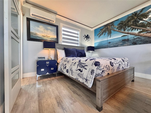 935 S Atlantic Ave Unit 244, Daytona Beach, FL 32118 - bedroom featuring a wall unit AC, wood finished floors, and baseboards