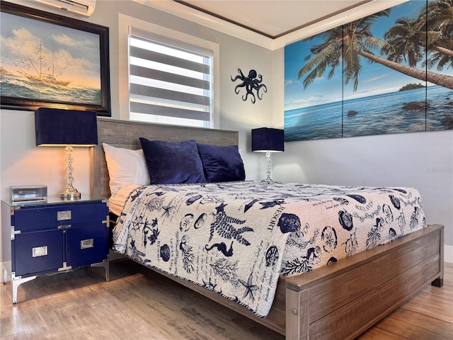 935 S Atlantic Ave Unit 244, Daytona Beach, FL 32118 - bedroom with wood finished floors, a wall mounted air conditioner, and baseboards