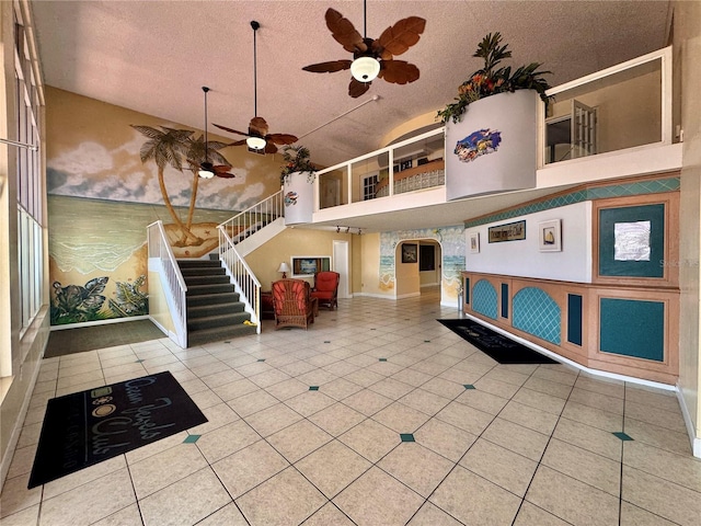 935 S Atlantic Ave Unit 244, Daytona Beach, FL 32118 - common area with stairs, a textured ceiling, and high vaulted ceiling