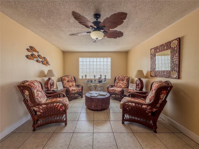 935 S Atlantic Ave Unit 244, Daytona Beach, FL 32118 - living room with plenty of natural light, a textured ceiling, a ceiling fan, tile patterned flooring, and baseboards