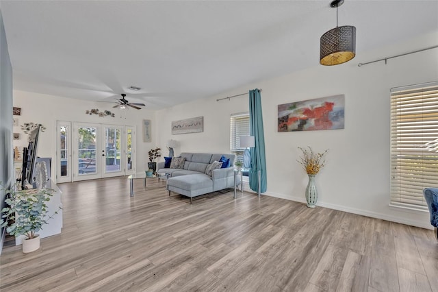 9455 Belmont Ter, Oviedo, FL 32765 - living area featuring light wood-style floors, ceiling fan, and french doors