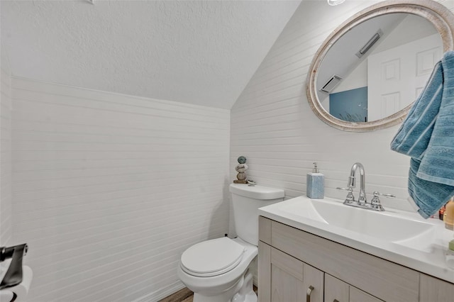 9455 Belmont Ter, Oviedo, FL 32765 - bathroom featuring vanity, toilet, lofted ceiling, tile walls, and a textured ceiling