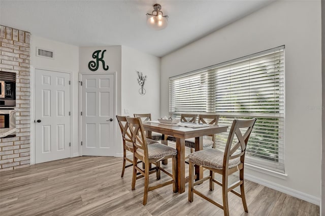 9455 Belmont Ter, Oviedo, FL 32765 - dining room with plenty of natural light, light wood-style floors, and baseboards