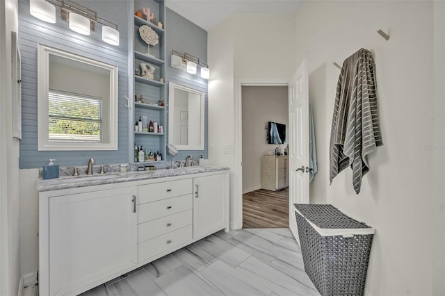 9455 Belmont Ter, Oviedo, FL 32765 - bathroom with double vanity and baseboards