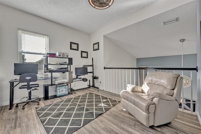 9455 Belmont Ter, Oviedo, FL 32765 - home office with a textured ceiling, wood finished floors, lofted ceiling, and baseboards