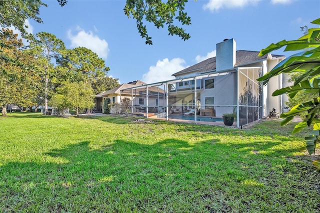 9455 Belmont Ter, Oviedo, FL 32765 - back of property with a yard, a chimney, stucco siding, and a lanai