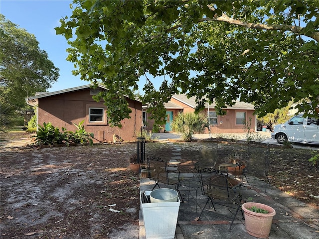 11314 Huggins St, Leesburg, FL 34788 - ranch-style home with stucco siding and a patio area
