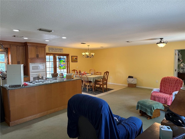 11314 Huggins St, Leesburg, FL 34788 - living room with a textured ceiling, recessed lighting, a chandelier, light colored carpet, and baseboards