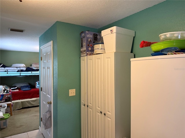 11314 Huggins St, Leesburg, FL 34788 - kitchen with carpet flooring, tile patterned flooring, a textured wall, and a textured ceiling