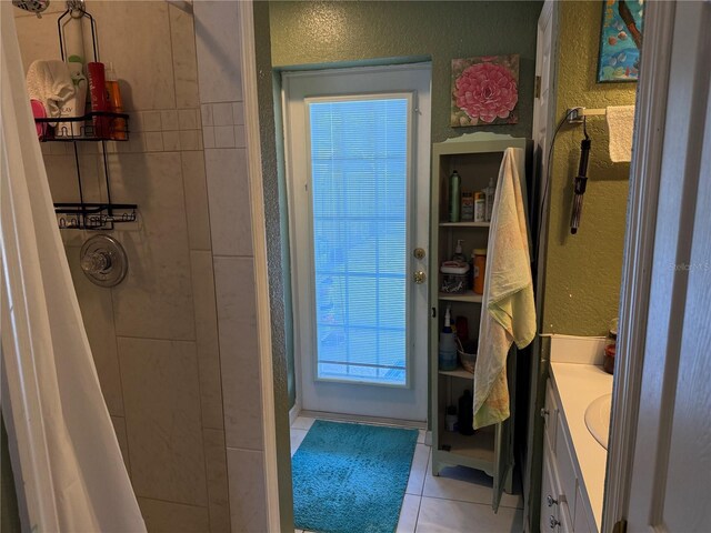 11314 Huggins St, Leesburg, FL 34788 - full bath with a textured wall, vanity, tile patterned floors, and tiled shower
