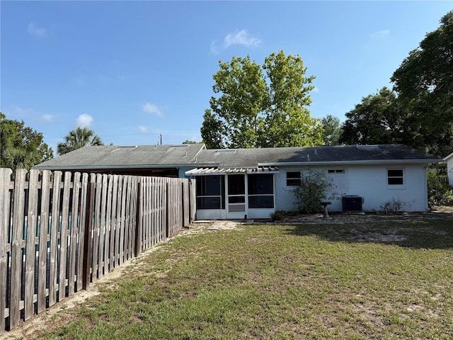 11314 Huggins St, Leesburg, FL 34788 - back of property with central air condition unit, a sunroom, and a shingled roof