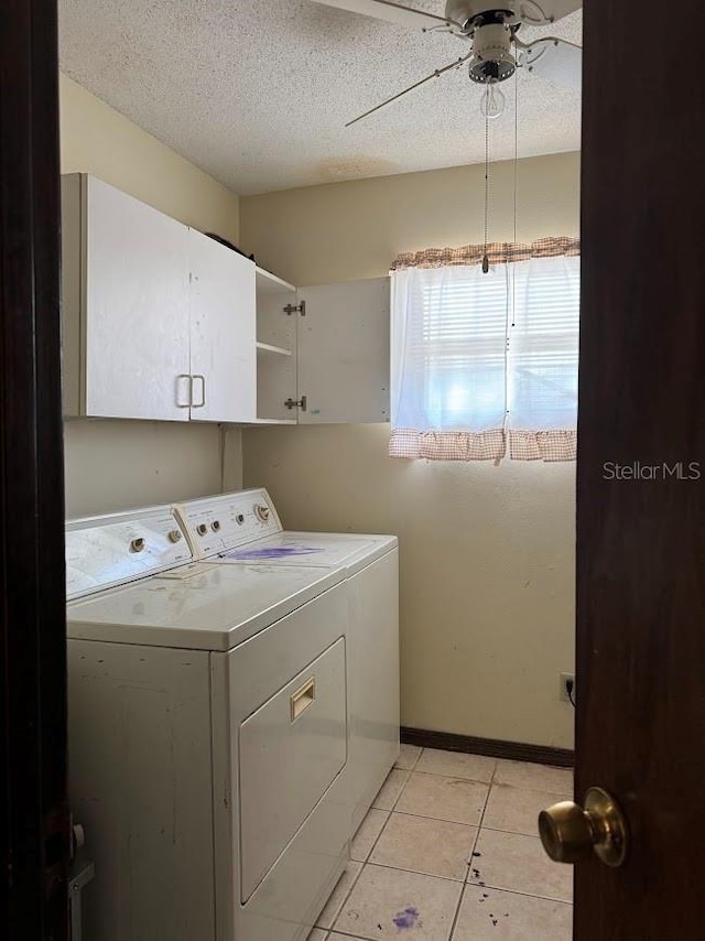6616 Blanche Ct, Orlando, FL 32818 - laundry room featuring washer and clothes dryer, cabinet space, ceiling fan, light tile patterned floors, and a textured ceiling