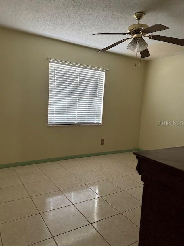 6616 Blanche Ct, Orlando, FL 32818 - spare room featuring light tile patterned flooring, ceiling fan, a textured ceiling, and baseboards