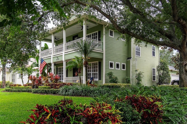 8335 Lake Burden Cir, Windermere, FL 34786 - rear view of property with a balcony, a ceiling fan, a porch, and a lawn