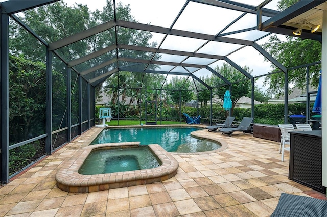 8335 Lake Burden Cir, Windermere, FL 34786 - view of pool with a patio area, a pool with connected hot tub, and glass enclosure