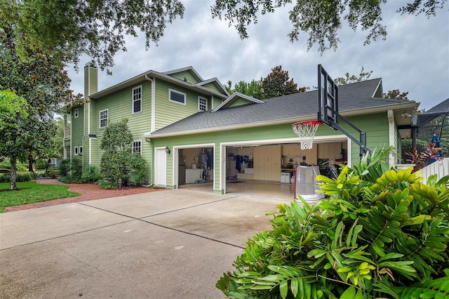 8335 Lake Burden Cir, Windermere, FL 34786 - view of side of property featuring a garage, driveway, and a chimney