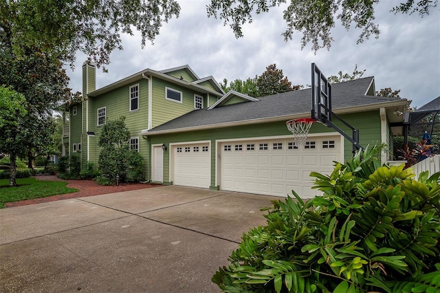 8335 Lake Burden Cir, Windermere, FL 34786 - view of property exterior featuring concrete driveway, an attached garage, and a chimney