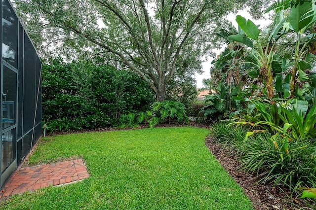 8335 Lake Burden Cir, Windermere, FL 34786 - view of green lawn featuring a lanai
