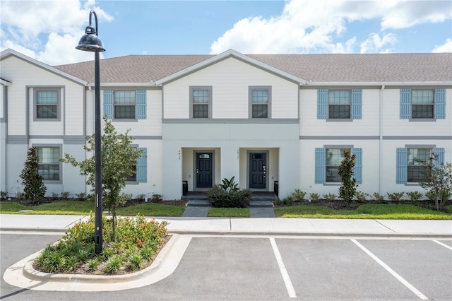 2439 Dubai St, Kissimmee, FL 34747 - townhome / multi-family property with uncovered parking, stucco siding, and a shingled roof