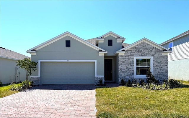 131 Addle Hill Ct, Deland, FL 32720 - view of front facade with stone siding, stucco siding, decorative driveway, and a front yard