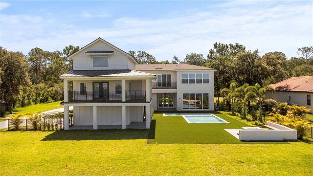 7706 Ficquette Rd, Windermere, FL 34786 - back of house with a balcony, a standing seam roof, a metal roof, and a patio