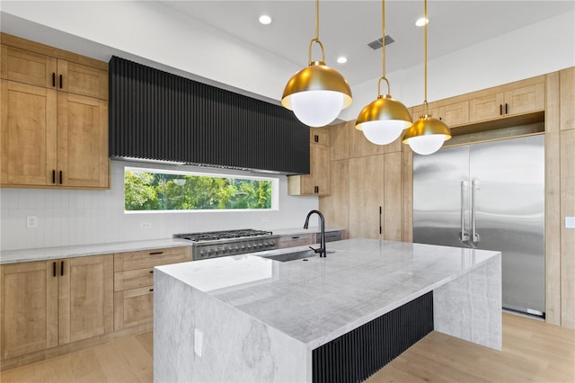 7706 Ficquette Rd, Windermere, FL 34786 - kitchen featuring appliances with stainless steel finishes, exhaust hood, light stone counters, light wood-style flooring, and recessed lighting