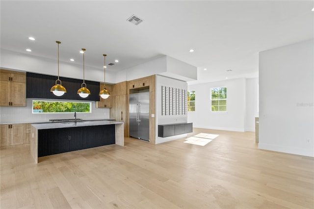 7706 Ficquette Rd, Windermere, FL 34786 - kitchen featuring built in refrigerator, open floor plan, light wood-style floors, recessed lighting, and an island with sink