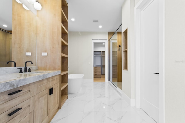 7706 Ficquette Rd, Windermere, FL 34786 - bathroom featuring vanity, a soaking tub, a walk in closet, recessed lighting, and marble finish floors