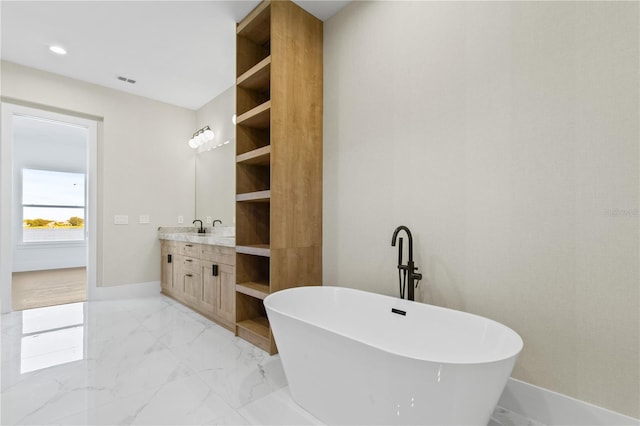 7706 Ficquette Rd, Windermere, FL 34786 - full bath with a freestanding tub, vanity, marble finish flooring, and recessed lighting