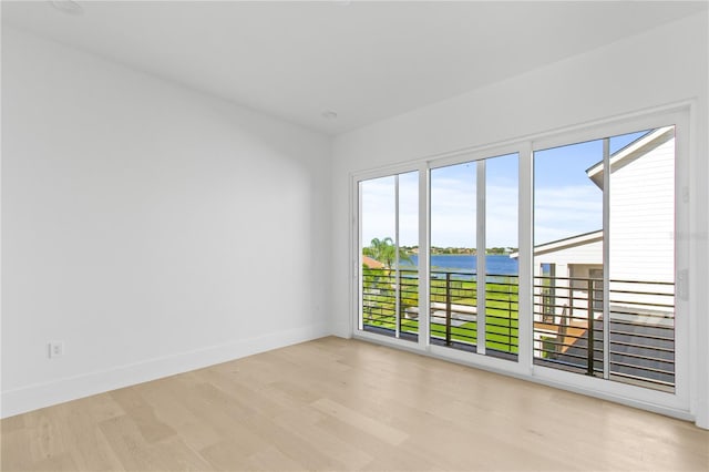 7706 Ficquette Rd, Windermere, FL 34786 - spare room with light wood-style floors and a water view