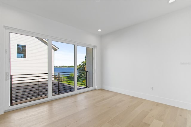 7706 Ficquette Rd, Windermere, FL 34786 - empty room with light wood-type flooring, recessed lighting, and a water view